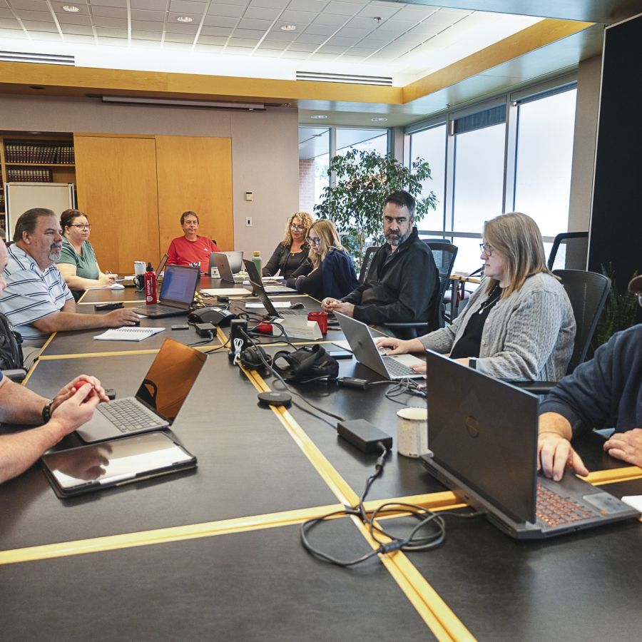 A group of people working around a table.