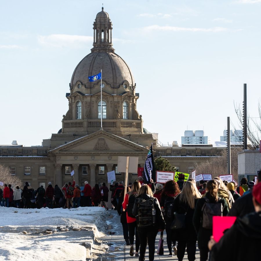 A protest march heading towards the Alberta Legislature building.
