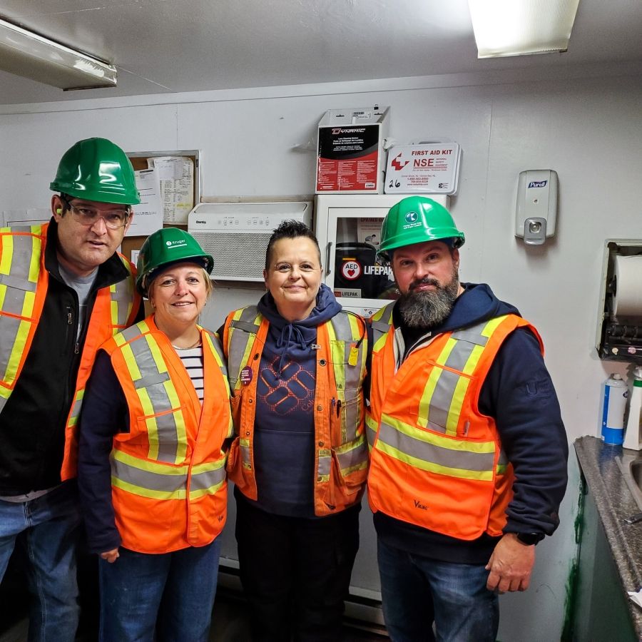 Unifor Atlantic Regional Director Jennifer Murray and three other people in high-vis vest and hard hats.