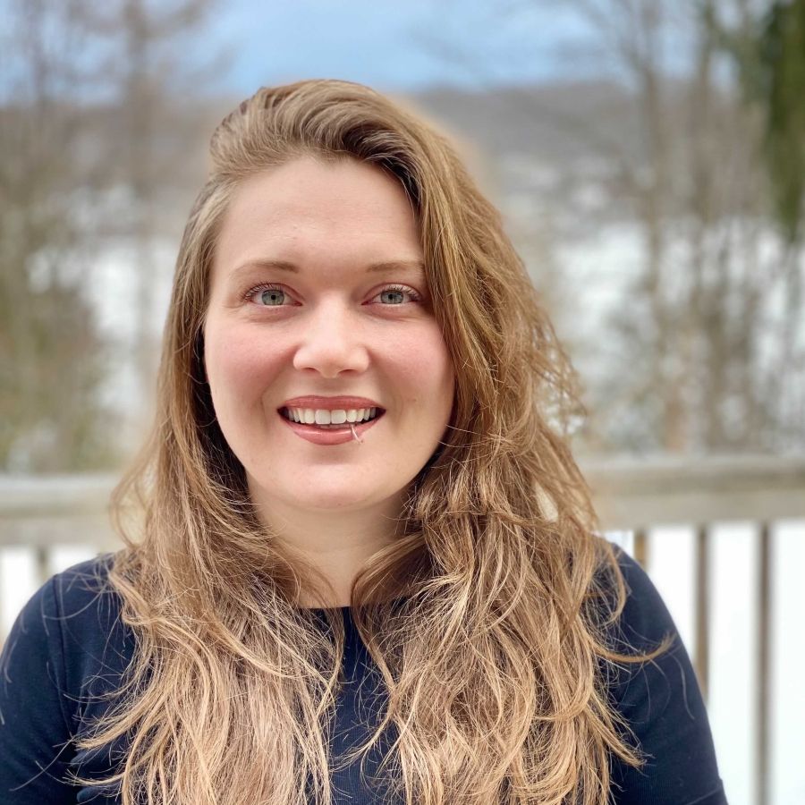 Sarah McCue stands in front of snowy field