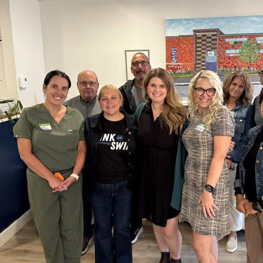 Unifor Atlantic Regional Director Jennifer Murray standing in an office with eight other people.