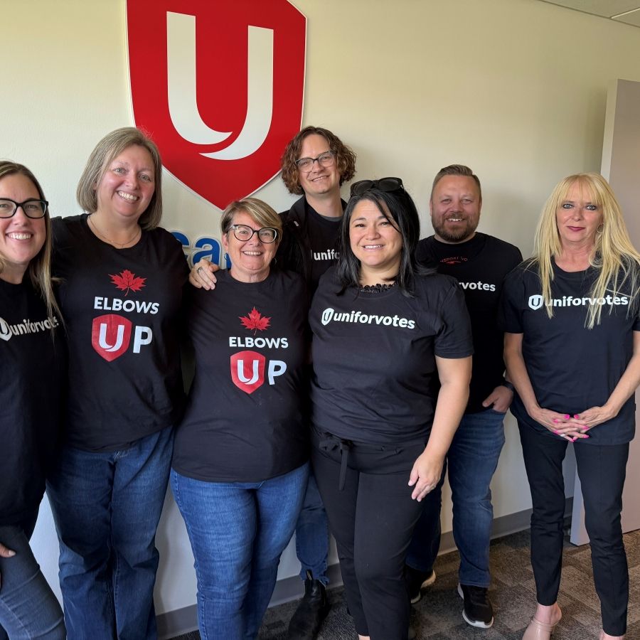 A group of seven people in Unifor Votes and Unifor Elbows Up t-shirts.