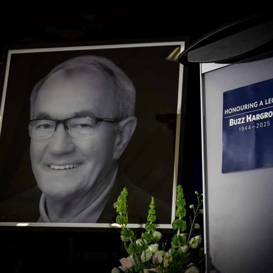 image of Buzz Hargrove with flowers and a podium