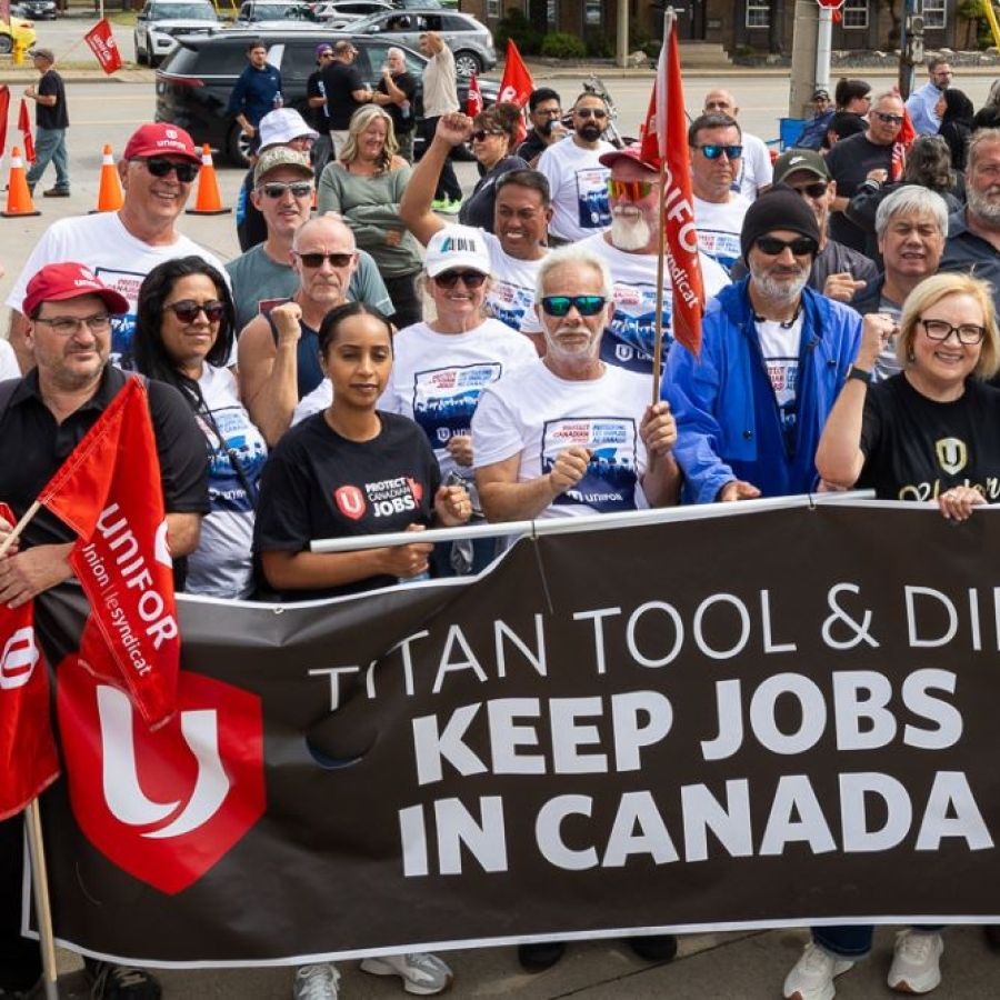 group of people holding rally banner 