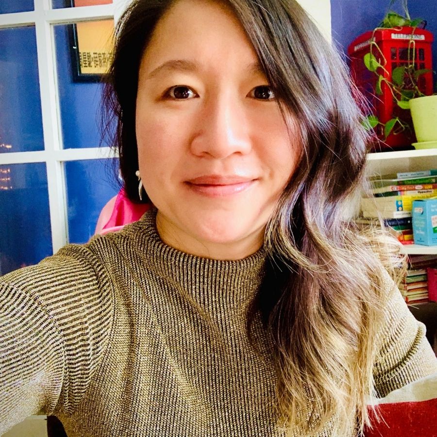 Jenny Yuen stands in her home office